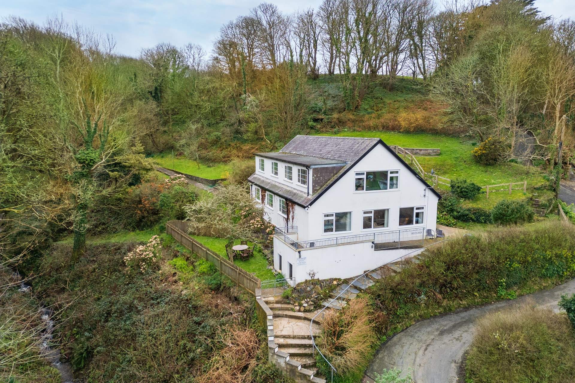 A set of steps take you up to gorgeous Pen yr Onen. A ground floor apartment with pretty gardens, just a stone's throw from the beach. 