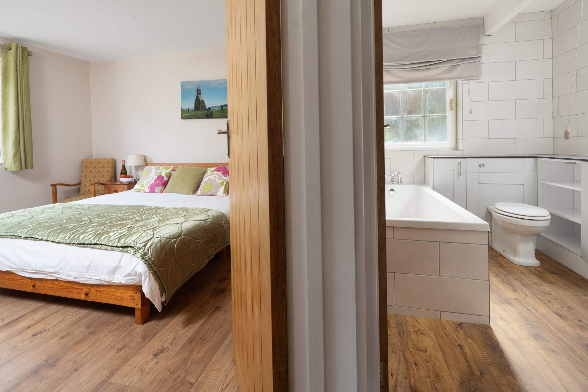 The king-size bedroom is adjacent to the family bathroom. You choose, bath or shower. 