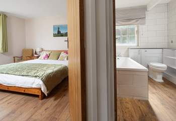 The king-size bedroom is adjacent to the family bathroom. You choose, bath or shower. 