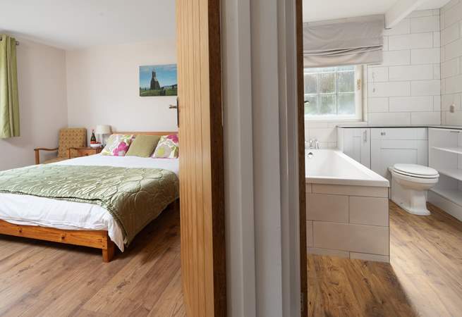 The king-size bedroom is adjacent to the family bathroom. You choose, bath or shower. 