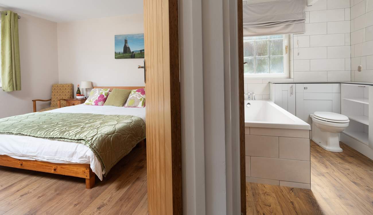 The king-size bedroom is adjacent to the family bathroom. You choose, bath or shower. 