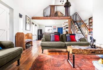 The open plan living space is light and airy - open tread stairs lead up to the mezzanine level.