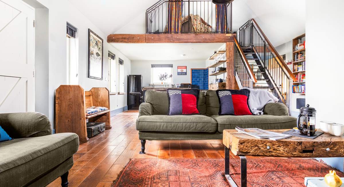 The open plan living space is light and airy - open tread stairs lead up to the mezzanine level.