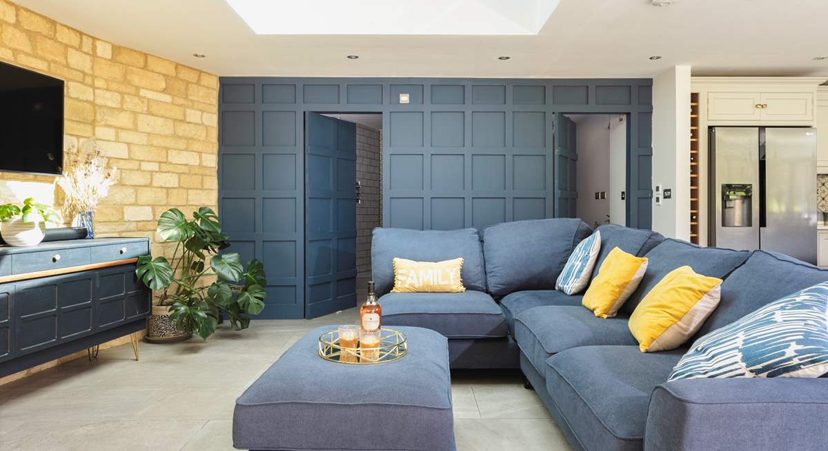 The cunningly designed wood panelled wall which hides a lovely shower-room and utility-area – very James Bond! 