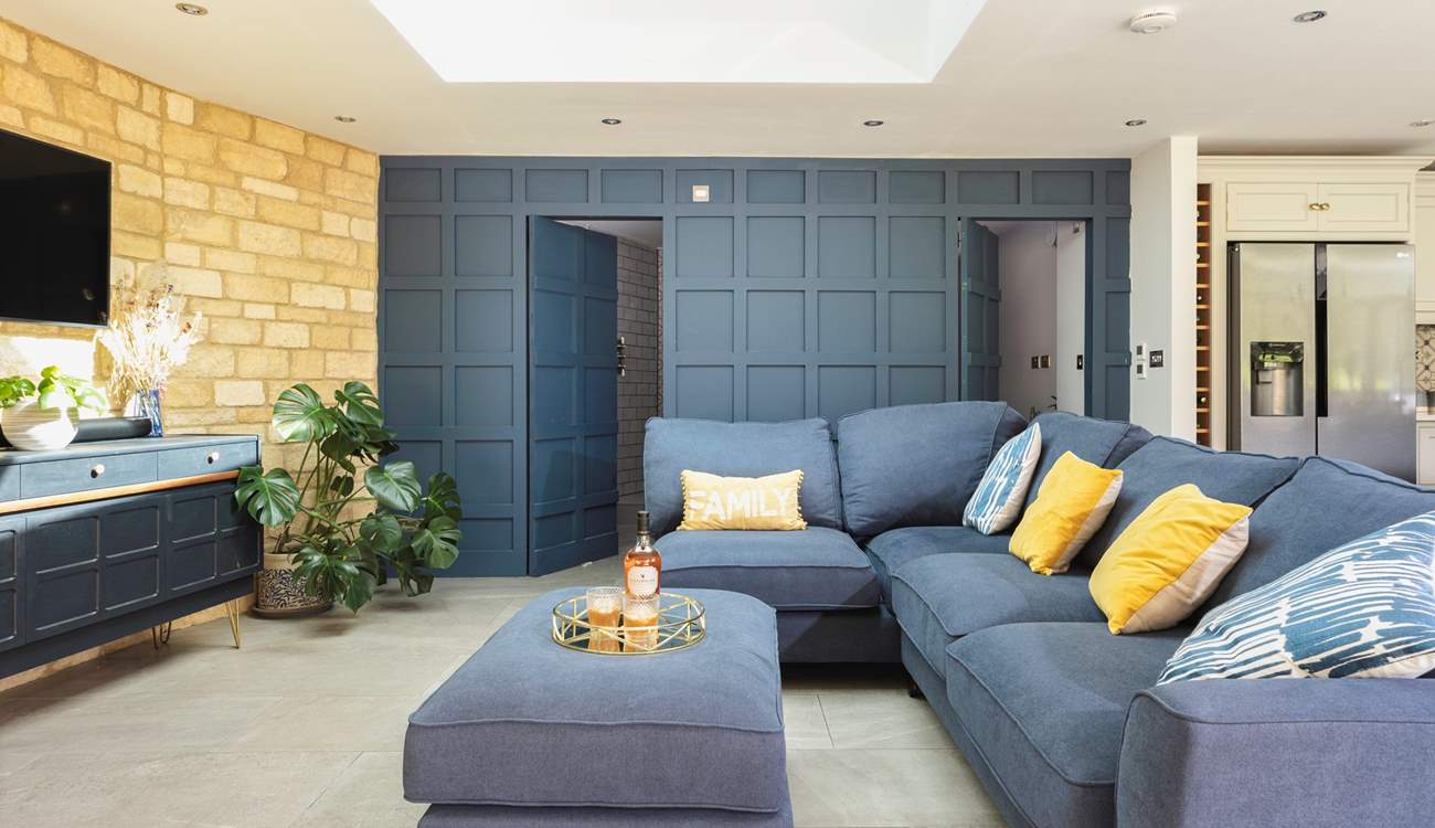 The cunningly designed wood panelled wall which hides a lovely shower-room and utility-area – very James Bond! 