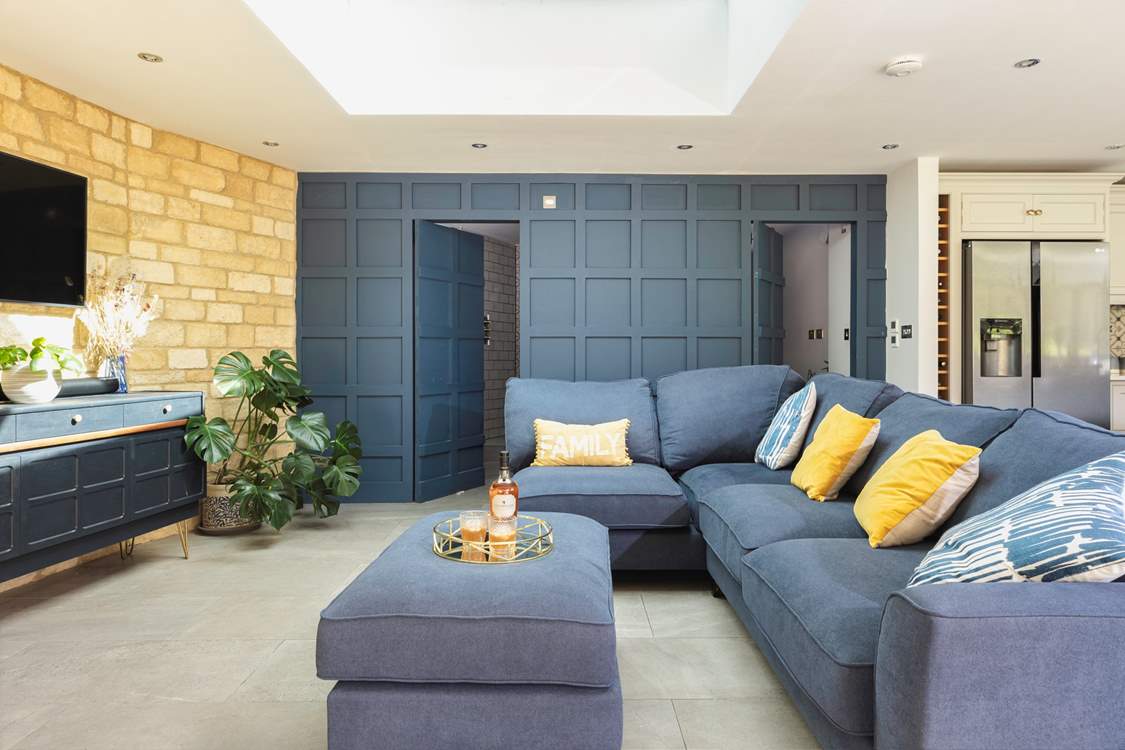 The cunningly designed wood panelled wall which hides a lovely shower-room and utility-area – very James Bond!