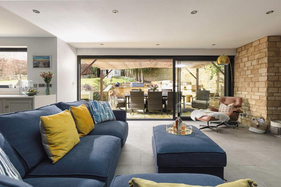 There is a delightful outdoor kitchen-area featuring a gas barbecue, pizza oven and smoker, perfect for al fresco dining and entertaining under the Cotswold skies.