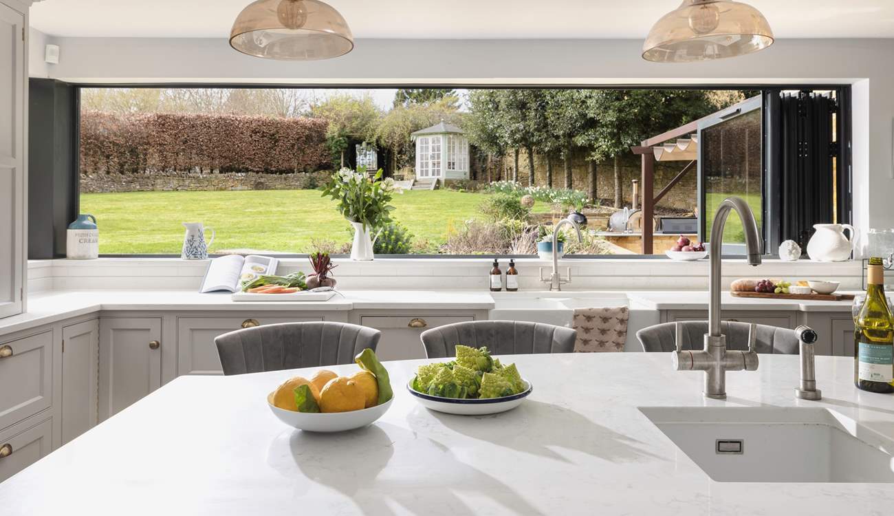 The incredible bi-folding window in the kitchen transforms the area into the perfect space to entertain, bringing the outside in.