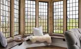 The double-aspect windows provide dreamy views across the village and there is a lovely window seat which lends itself to lazy days unwinding. - Thumbnail Image