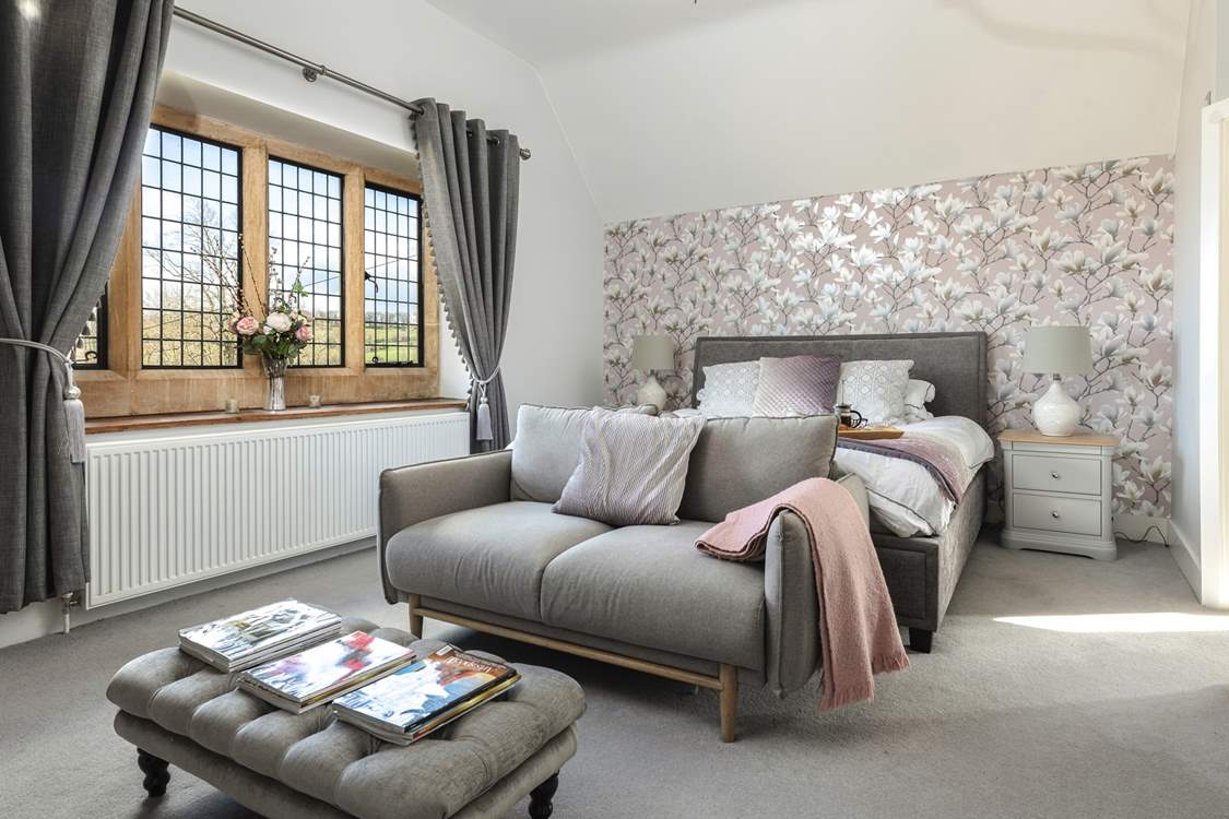 The main bedroom boasts an opulent super-king bed and comfy sofa.