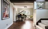 As you enter the hallway you are greeted by a beautiful grand piano and contemporary pieces of art. - Thumbnail Image