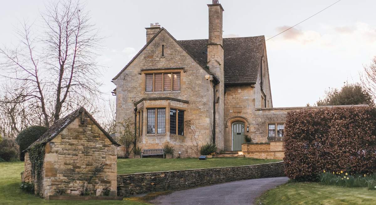 A sweeping driveway guides you to this impressive residence.