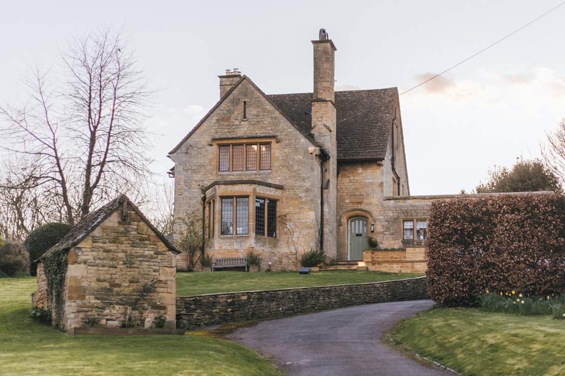 A sweeping driveway guides you to this impressive residence.