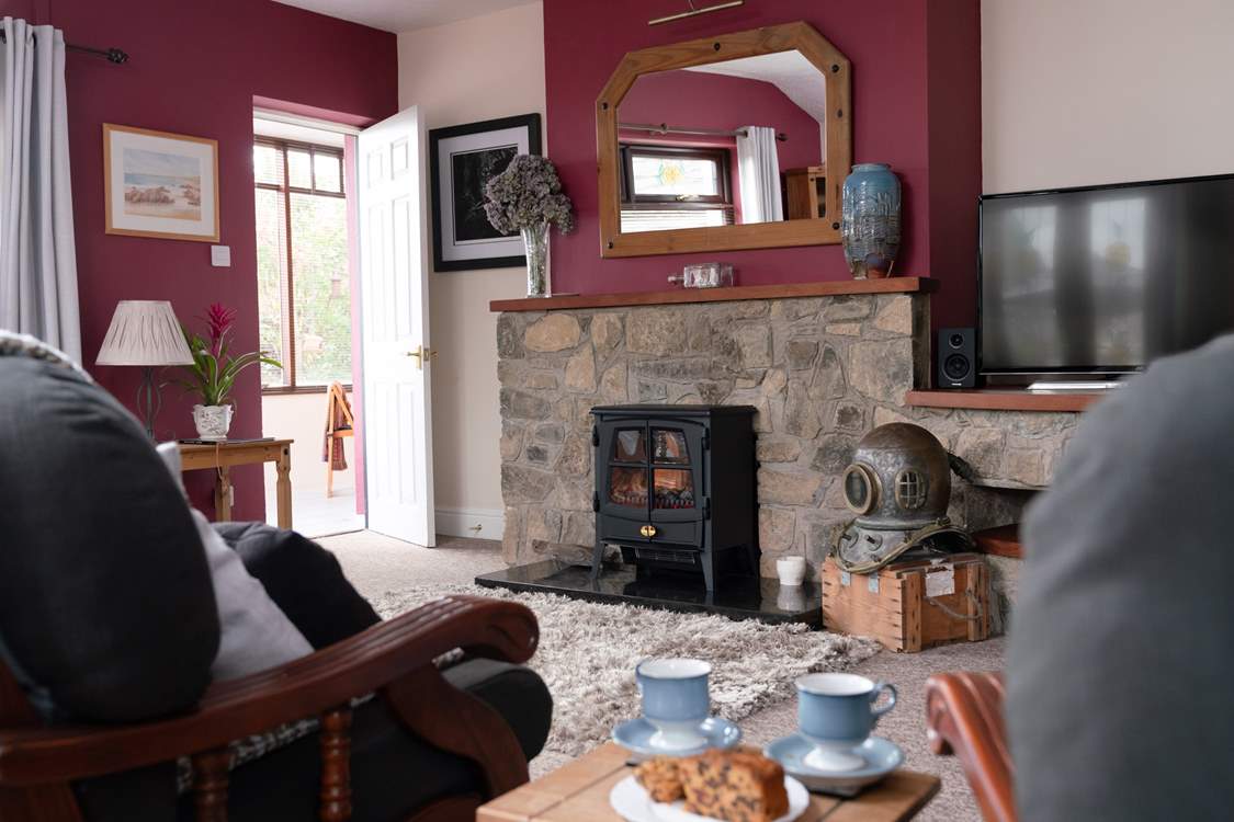 Open the sitting-room doors which lead into the garden for a gentle, cooling breeze. Just steps away is the hot tub.