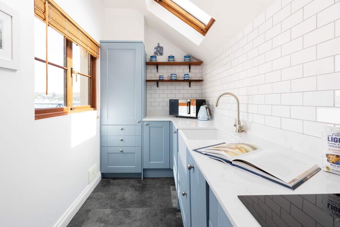 The galley kitchen has a handy serving hatch and a window which also looks out to the sea.