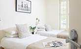 Gorgeous shutters, crisp white linens and soft fabrics create a calming room. - Thumbnail Image