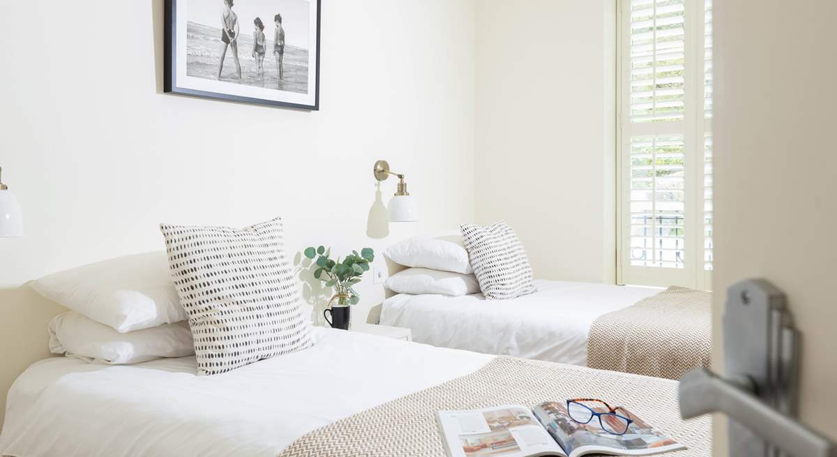 Gorgeous shutters, crisp white linens and soft fabrics create a calming room.