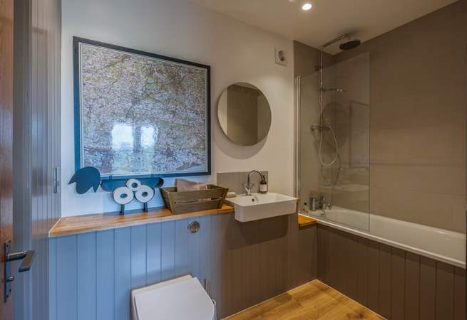 The bathroom has a shower and bath.