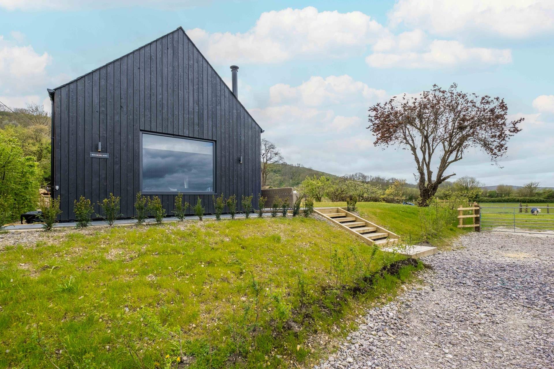 Steps from the parking area lead to the barn.