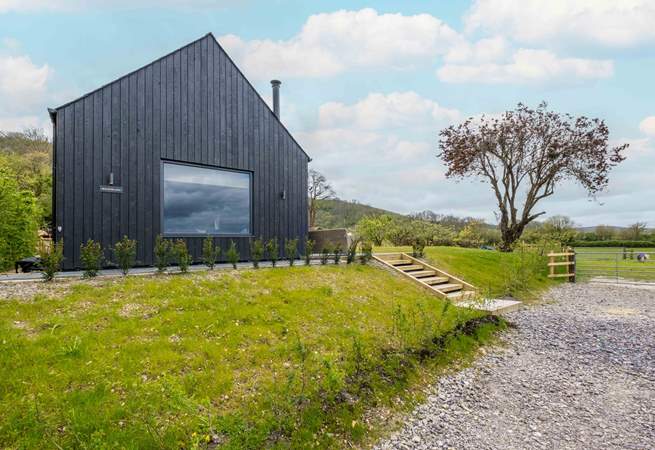 Steps from the parking area lead to the barn.