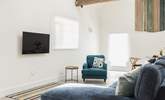 Comfy seating complemented by the owners' hand crafted wall hanging. - Thumbnail Image