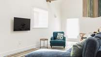 Comfy seating complemented by the owners' hand crafted wall hanging.