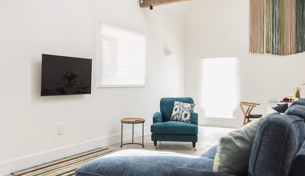 Comfy seating complemented by the owners' hand crafted wall hanging.