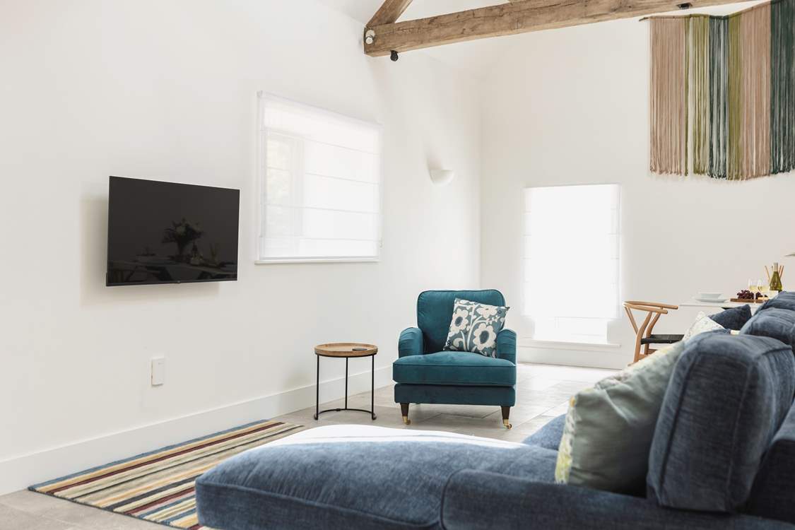 Comfy seating complemented by the owners' hand crafted wall hanging.
