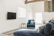 Comfy seating complemented by the owners' hand crafted wall hanging.