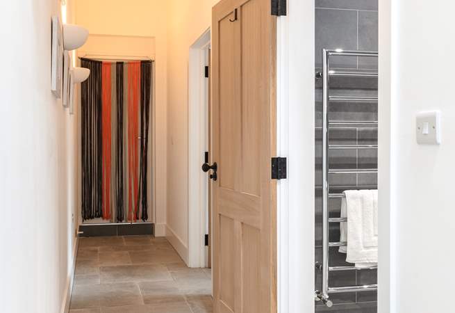 Looking down the hallway towards the bedroom and shower-room on the right.