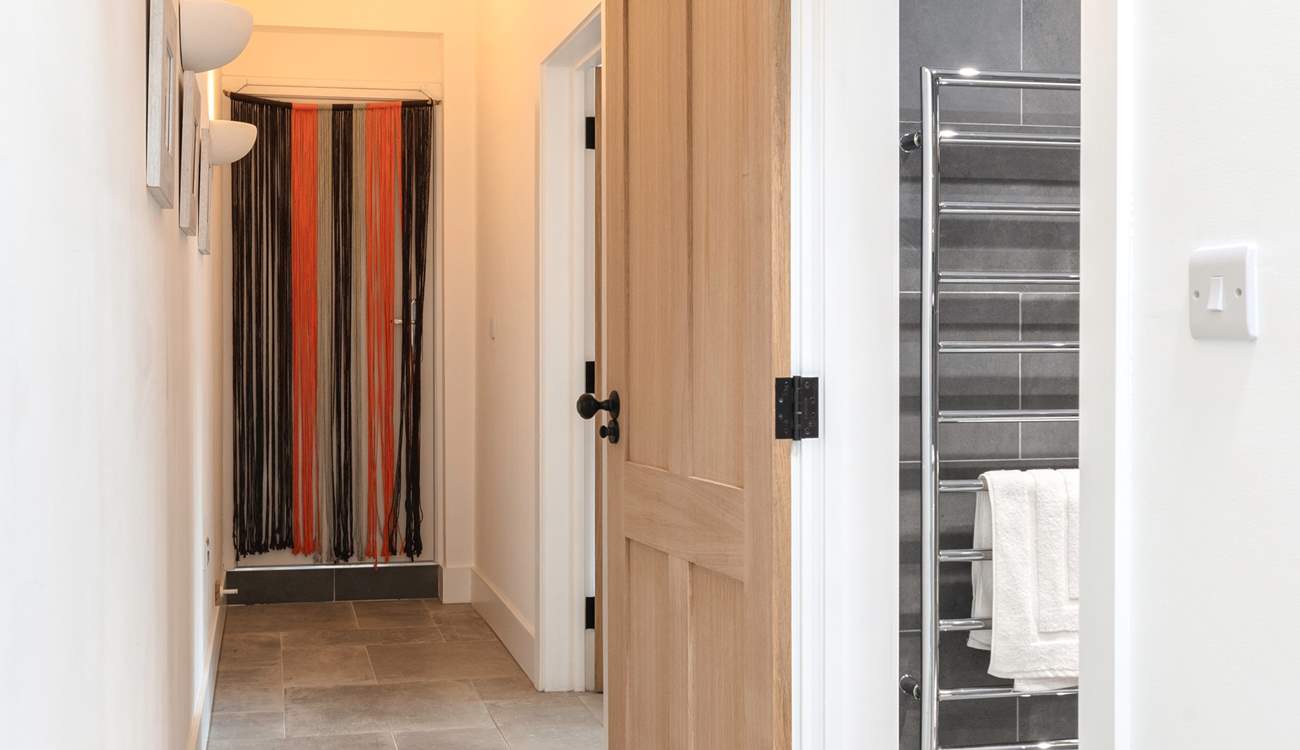 Looking down the hallway towards the bedroom and shower-room on the right.