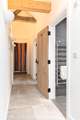 Looking down the hallway towards the bedroom and shower-room on the right.