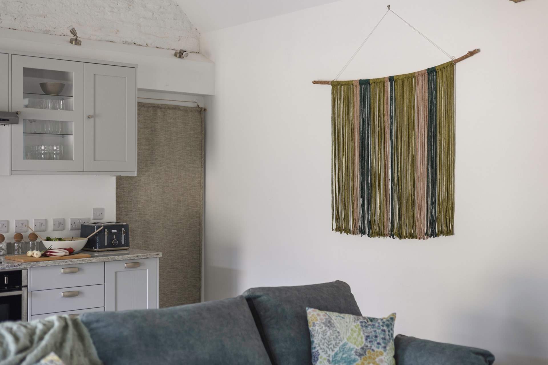 The owners' hand crafted wall hanging is a beautiful feature of this room.