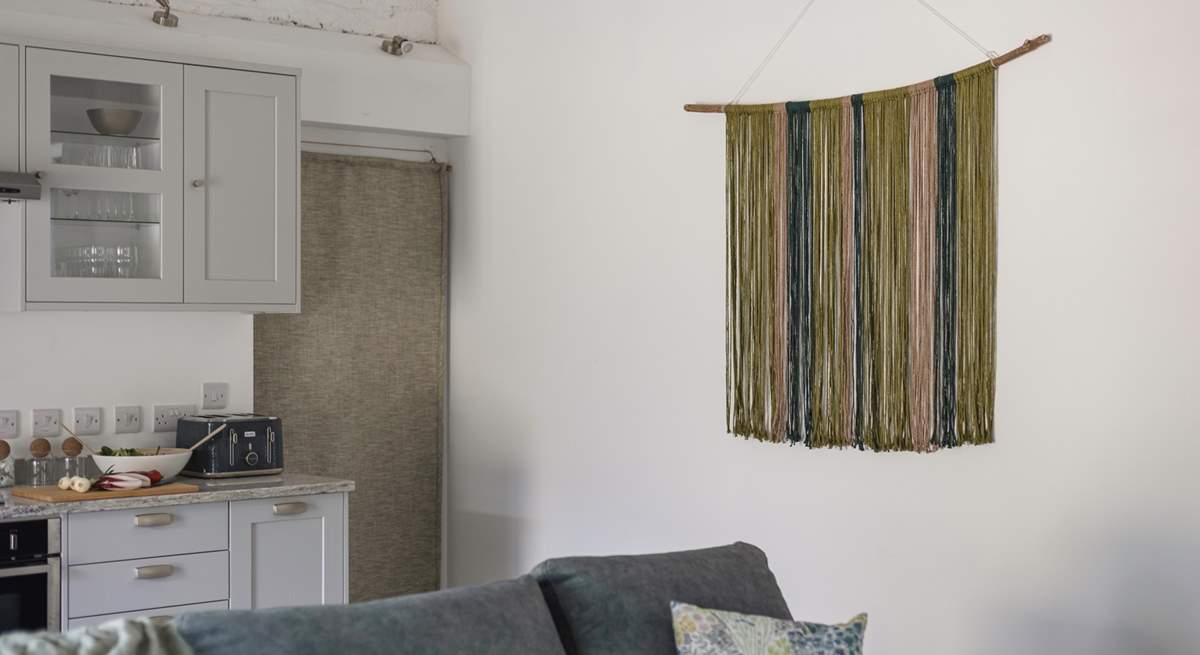 The owners' hand crafted wall hanging is a beautiful feature of this room.