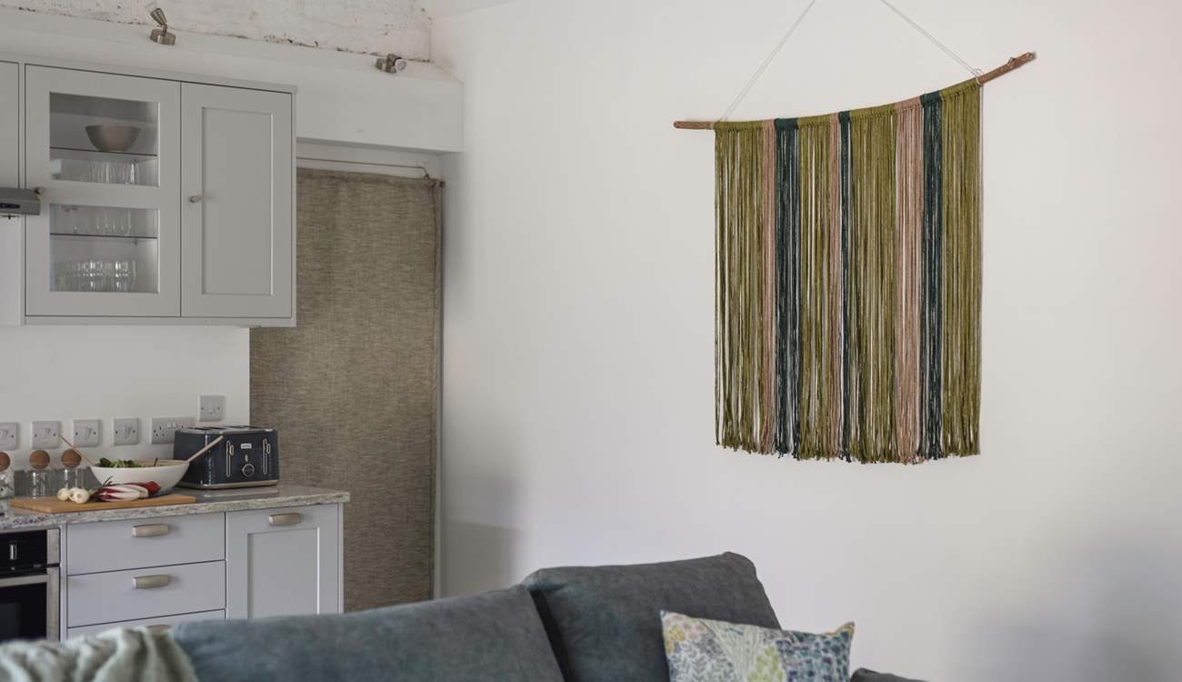 The owners' hand crafted wall hanging is a beautiful feature of this room.
