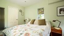 The ground floor bedroom is a peaceful retreat.