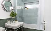 One of the beautifully styled bathrooms with overhead shower. - Thumbnail Image