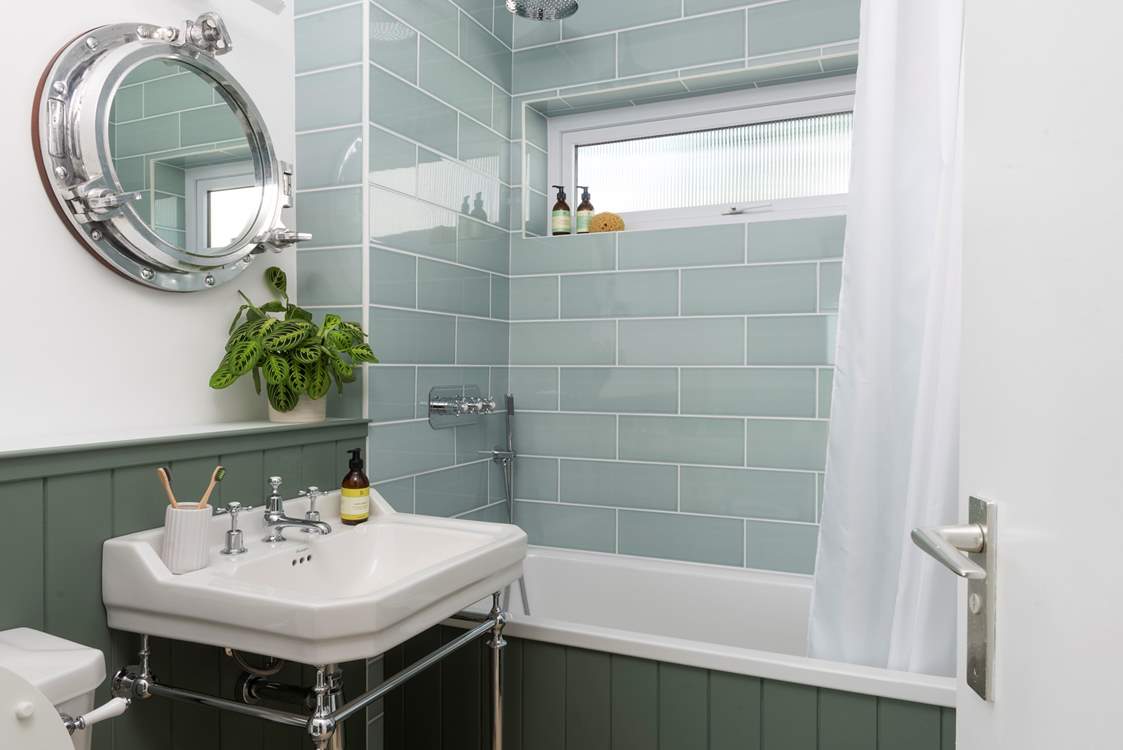 One of the beautifully styled bathrooms with overhead shower.