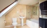 This twin bedroom has its own en suite bathroom, where a bath and fitted shower await. - Thumbnail Image