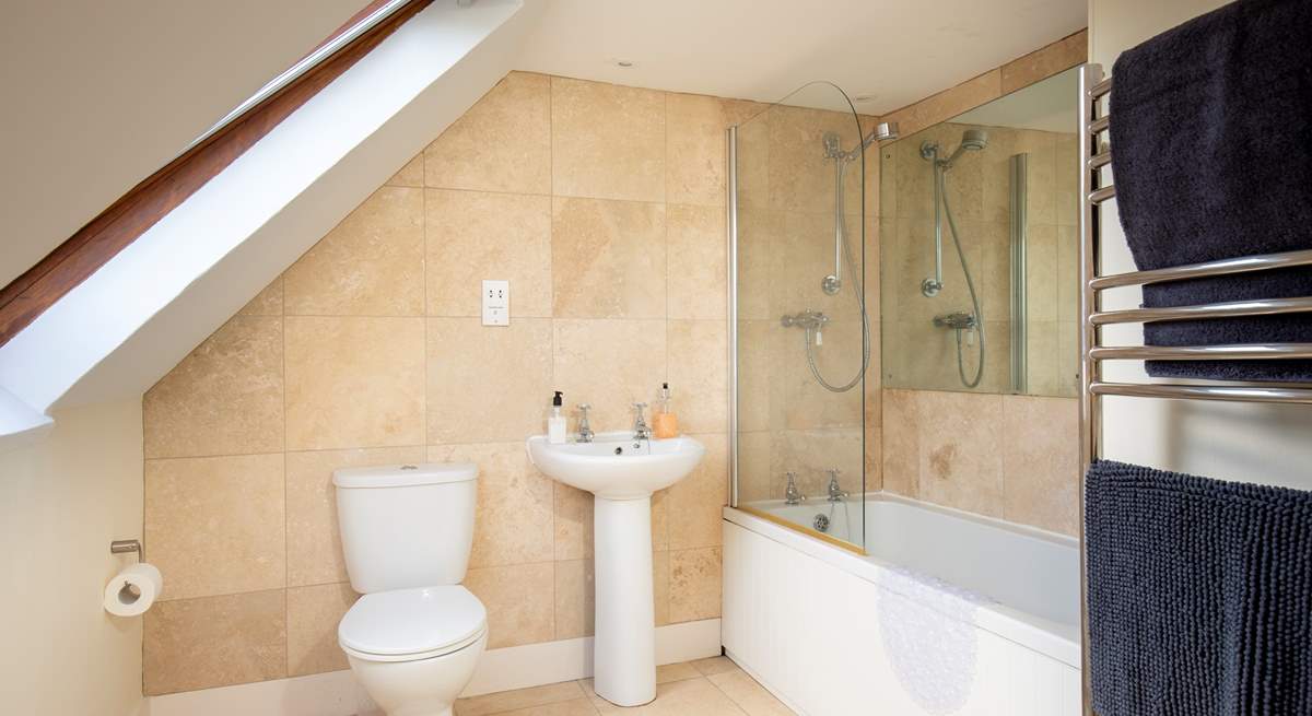 This twin bedroom has its own en suite bathroom, where a bath and fitted shower await.