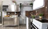 The industrial style kitchen is beautifully appointed with everything you need to fuel your beach days. - Thumbnail Image