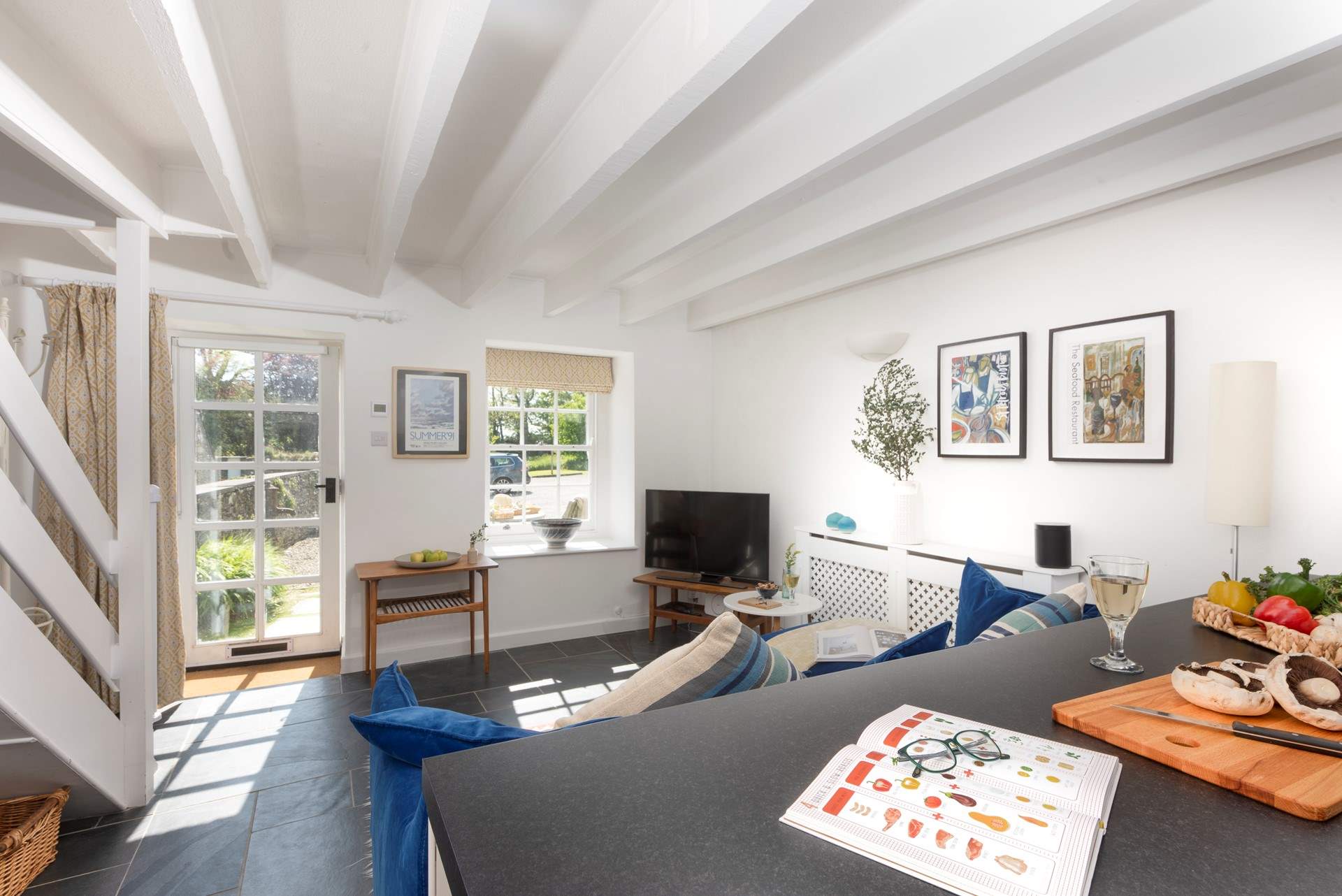 The sun streams in the open plan living-room.