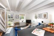 The sun streams in the open plan living-room.