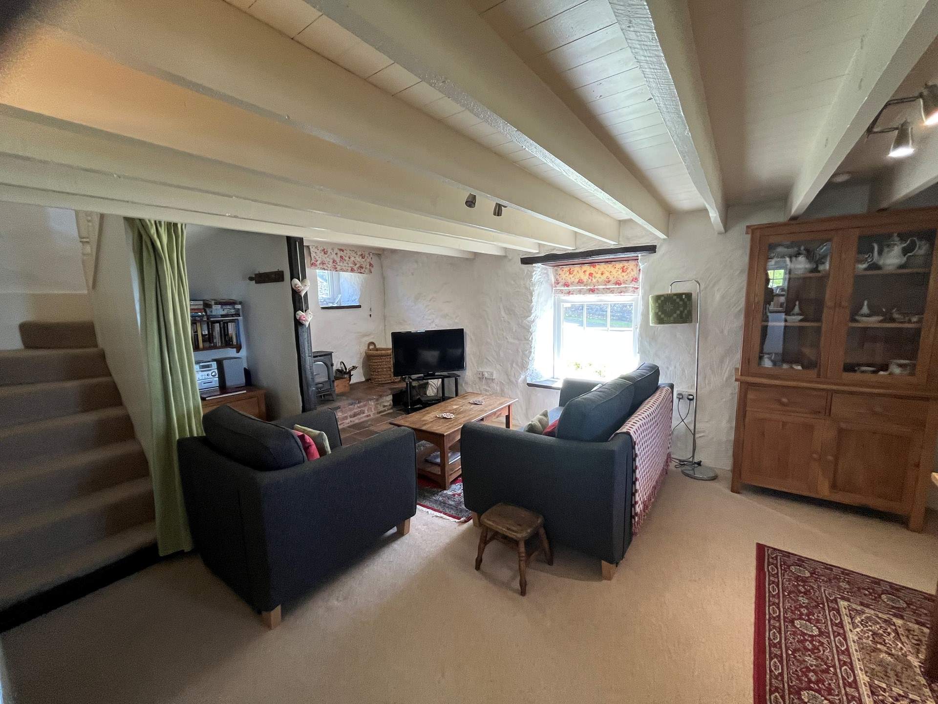 Gather around the flickering wood-burner after a day hiking the coastal path.