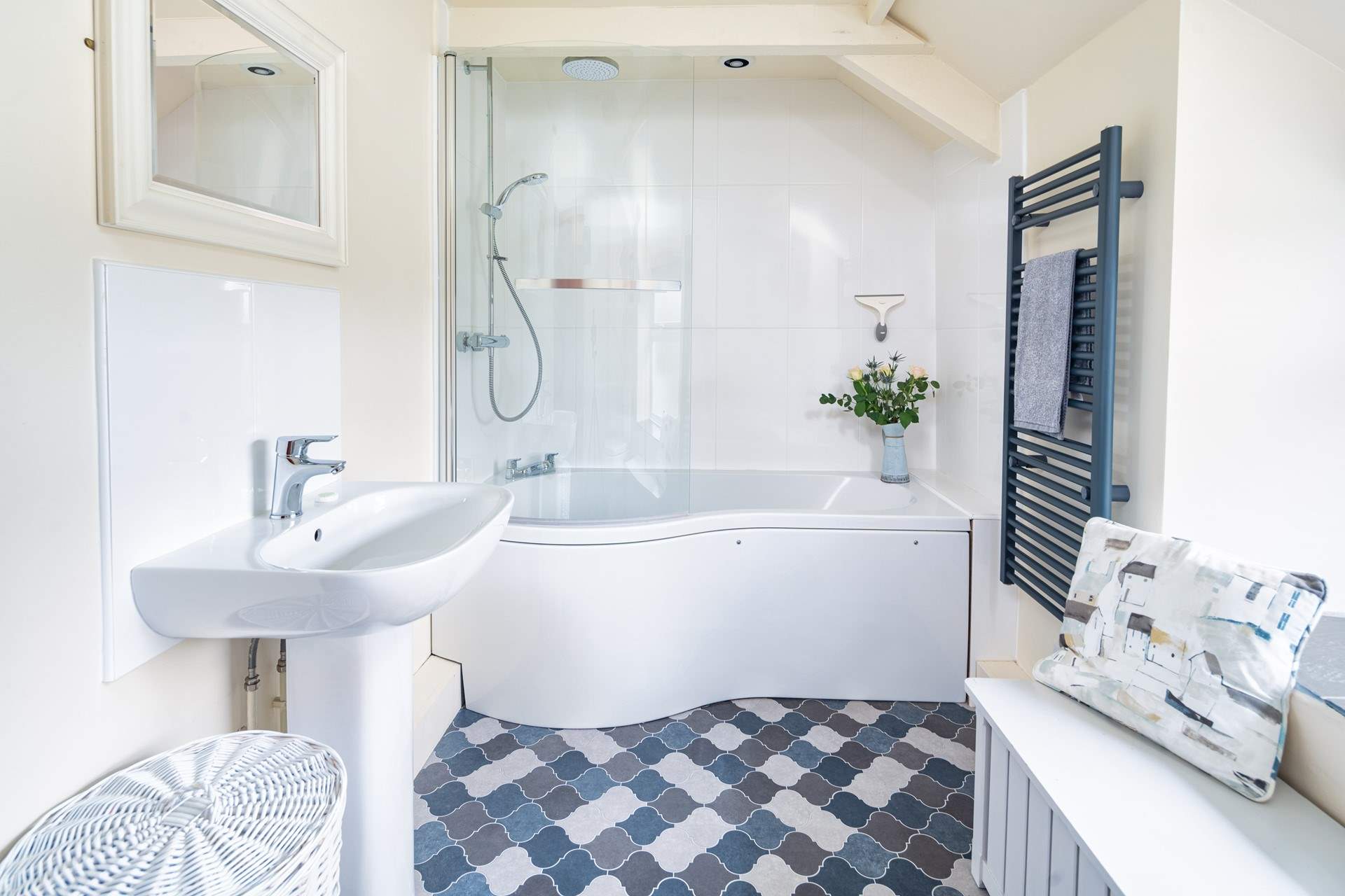 Blue hues in the  light and airy bathroom. 