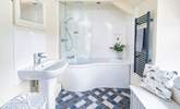 Blue hues in the  light and airy bathroom.  - Thumbnail Image