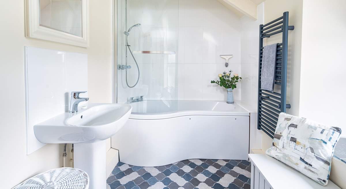 Blue hues in the  light and airy bathroom. 