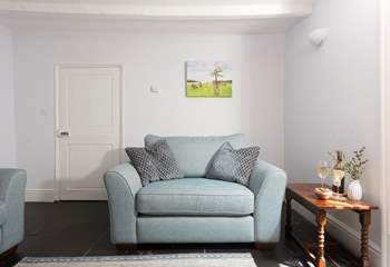 Enjoy a snuggle on the love seat at Grove Cottage. 