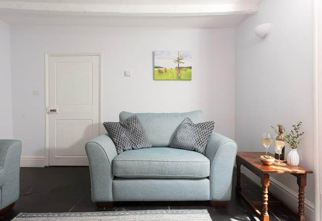 Enjoy a snuggle on the love seat at Grove Cottage. 