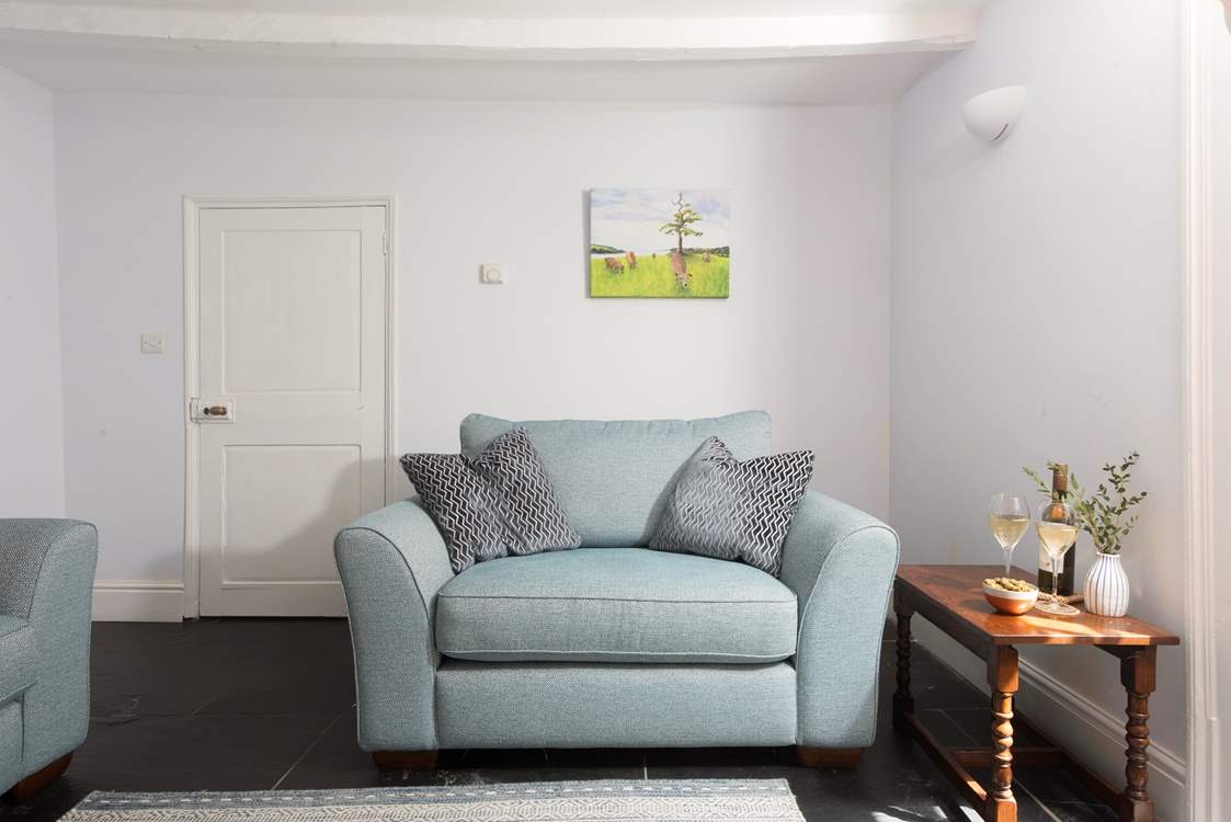 Enjoy a snuggle on the love seat at Grove Cottage.